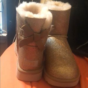 Never worn UGGs. Gold Sparkle Bailey Bow Size 10.
